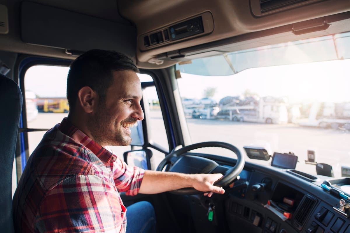 Truck driver smiling in cab
